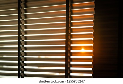 Opened venetian plastic blinds with sunlight in the morning. White plastic window with blinds. Interior design of living room with window horizontal blinds. Window slatted shades made of plastic. - Powered by Shutterstock