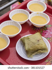 Opened Vietnamese sticky rice cake,banh chung , for the New Year holiday,Tet. containing rice, pork, mung beans wrapped in banana leaves. With bowls of Hoi An corn sweetened porridge from Cam Nam corn