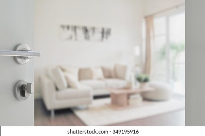 Opened White Door To Modern Living Room Interior