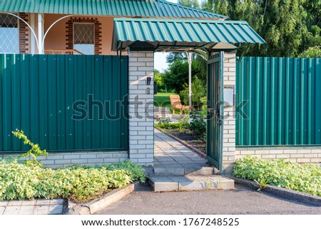 opened wicket gate door to a private house