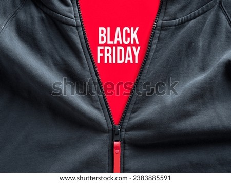 Opened zipper of a hoodie showing the word black Friday on a tag. Black Friday sale in fashion and casual sportwear clothing.