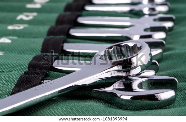 Open-end wrench set\
on green cover.\
Close-up