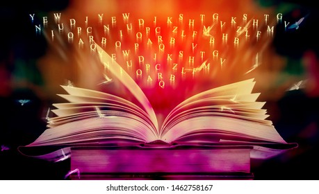 Opening book with magic power on the table and the English alphabet floating