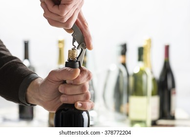 Opening Bottle Of Wine With Corkscrew