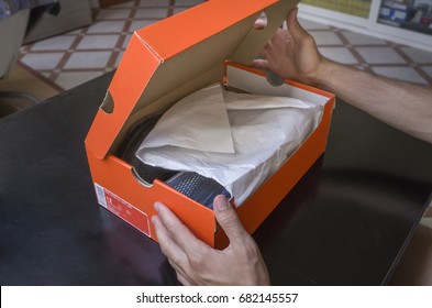 Opening The Box Of A New Pair Of Shoes