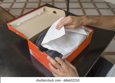 Opening the box of a new pair of shoes