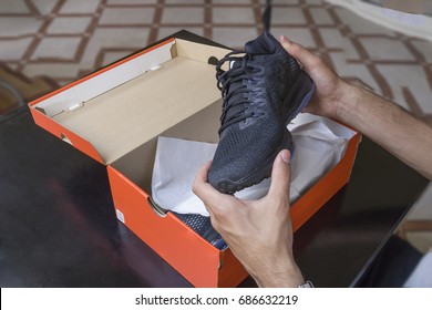Opening the box of a new pair of shoes