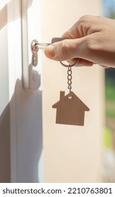 Opening A Door To House With Key. Closeup Of A Hand Open A Lock With Key In Keyhole. Landlord Unlocks The House Key For New Home. Real State, Security Home, Robbery, Alarm. Copy Space Vertical Banner