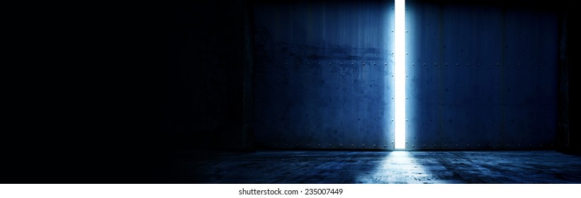opening a heavy steel door. Large steel doors of an hanger like building opening and light coming in. with plenty of copy space 