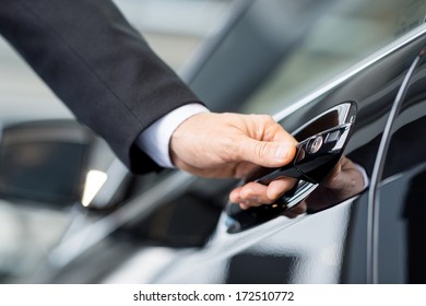 Opening His New Car. Close-up Of Male Hand Holding The Car Handle