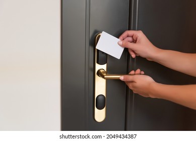 Opening a hotel room door with a magnetic key - Shutterstock ID 2049434387