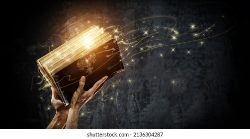 Opening a magical antique book - Shutterstock ID 2136304287