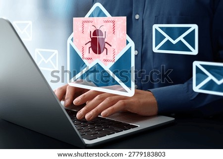 Opening malware-infected email. Security software detecting cyber threat. Businessman using laptop computer.