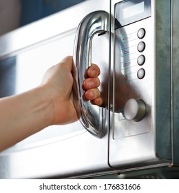 Opening Of Microwave Oven Door In Home Kitchen