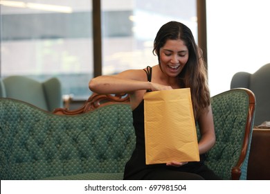 Opening Post Envelope And Looking Inside, Happy Young Woman, Sitting In The Office