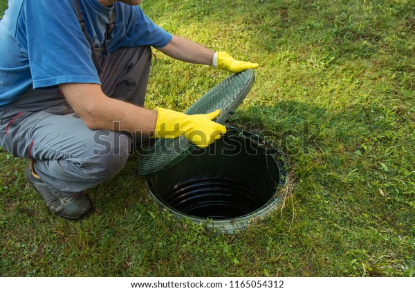 Opening septic tank lid. Cleaning and unblocking\
septic system and draining\
pipes.