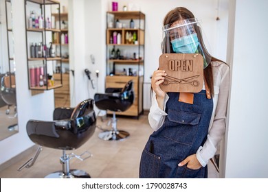 Opening Small Business After Covid-19 Pandemic. Portrait Of Elegant Hair Salon Employee In Apron With Medical Mask, Gloves, Hair Comb And Scissors. Hairdressers During COVID-19