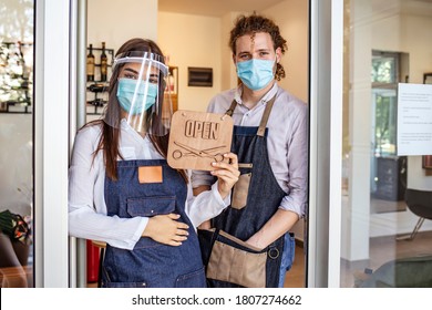 Opening Small Business After Covid-19 Pandemic. Portrait Of Elegant Hair Salon Employee In Apron With Medical Mask, Gloves, Hair Comb And Scissors. Hairdressers During COVID-19