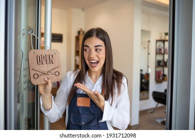 Opening Small Business After Covid-19 Pandemic. Closeup On Smiling Middle Aged Small Business Owner Woman In Apron With Crossed Fingers Showing Open Sign.