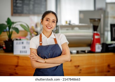 Opening a small business, AHappy Asian woman in an apron standing  near a bar counter coffee shop, Small business owner, restaurant, barista, cafe, Online, SME, entrepreneur, and  seller concept