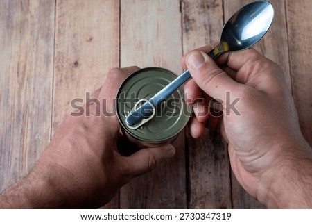 Opening Tin Can With Spoon