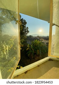 Opening The Window To See The Sunrise In The Morning More Clearly.