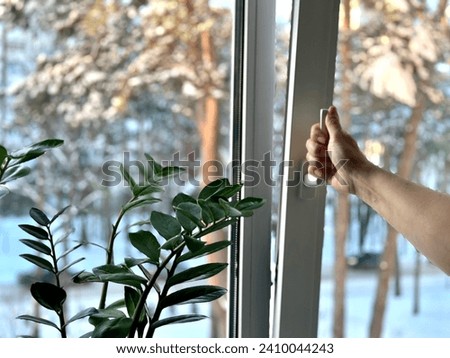Opening the window for ventilation in winter.
