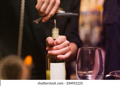 Opening A Wine Bottle With Corkscrew In A Bar