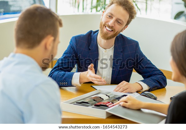 open-minded young caucasian consultant talking\
with customers, clients going to buy a new car in their dealership.\
automobile, car, auto, vehicle\
concept