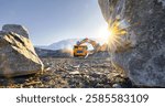 Open-pit coal mining in winter sunrise with heavy machinery and rocky terrain.