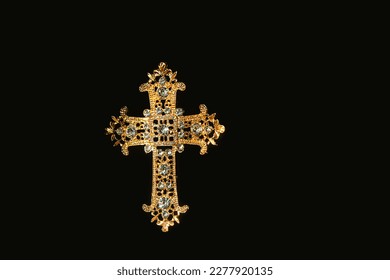 openwork decorated beautiful golden cross with rhinestones isolated on abstract black background close up. Cross - symbol of prayer, memory, Lent, Easter, Faith in God. element for design. flat lay - Shutterstock ID 2277920135