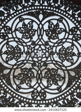 Openwork metal lattice with round elements and flowers