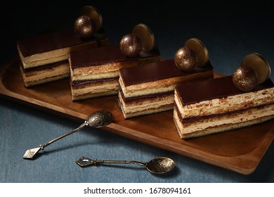 Opera cake at the a La carte desserts , cakes on a black background. Selective focus
