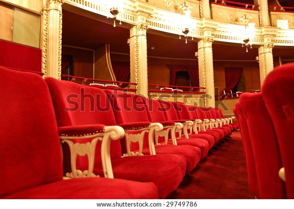 Opera House Interior - Seating\
arrangement, a row of seats with private boxes in the\
background