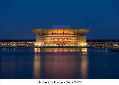 Opera House Of Modern Copenhagen In Denmark At Night. Famous Denmark Architecture At Night With Beautiful Illumination. Opera House Reflection In Copenhagen, Scandinavia. Copenhagen Opera Landmark.