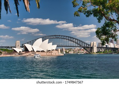 The Opera House And Sydney Harbour Bridge Viewed Across Farm Cove From Mrs Macquarie's Point, Sydney, New South Wales, Australia.  03-22-2018