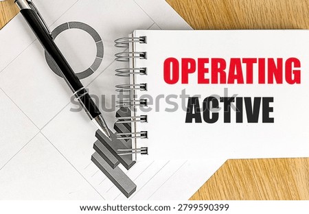 Operating active concept with notebook, pen and business charts on office desk representing operational status, workflow management. 