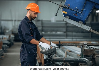 Operating the machine. Man is working in the modern factory.