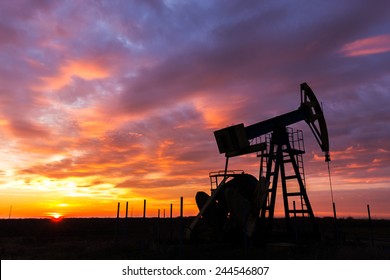 Operating Oil And Gas Well Profiled On Sunset Sky