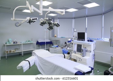 Operating room with covered table, different medical equipment, clean and prepared for the surgery