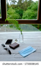 Operating Room Mask, Keys, Watch, Phone And Wallet On Wooden Table