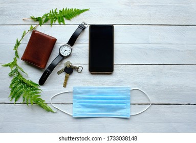 Operating Room Mask, Keys, Watch, Phone And Wallet On Wooden Table