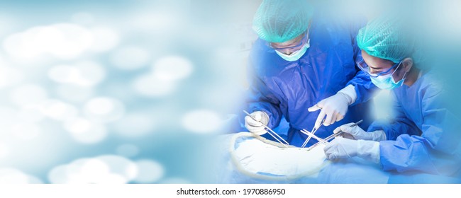 Operating Room of Surgical Table with Instruments, Assistant Picks up Instruments for Surgeons During Operation. Surgery in Progress. Professional Medical Doctors Performing Surgery.