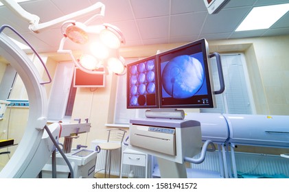 operating room with X-ray medical scan. real modern operating theater with working equipment, lights and computers.