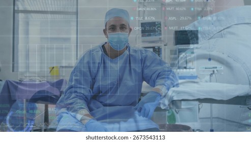 Operating surgeon in scrubs using instruments on surgical table in operating room, with monitors. Medical, healthcare, clinical, professional, sterile, technology, precision