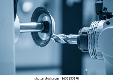 The operation of cutting tool making machine control by CNC program. The  cutting tools cutting grinding process by sharpening machine control by CNC program. - Powered by Shutterstock