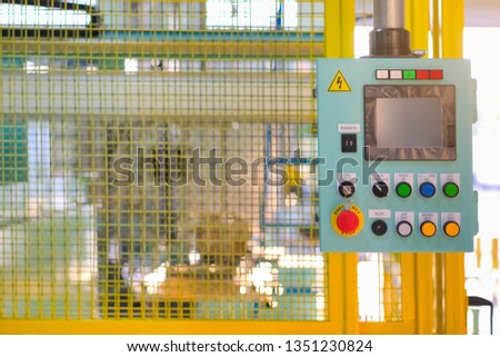 Operation panel of automation machine on yellow fence
