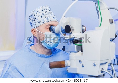Operation under a surgical microscope for vision correction. Eye surgery. A patient and a surgeon in the operating room during an ophthalmic operation. Treatment of eye cataracts