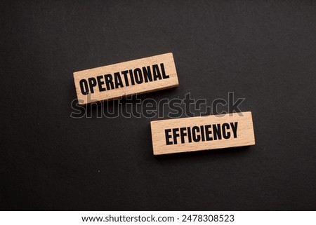 Operational efficiency message written on wooden blocks with black background. Conceptual operational efficiency symbol. Copy space.
