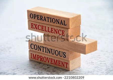 Operational excellence and continuous improvement text on wooden blocks. Business concept.